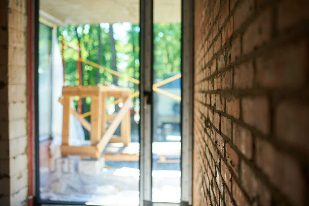 Building, construction site in progress to new house, brick wall in the room