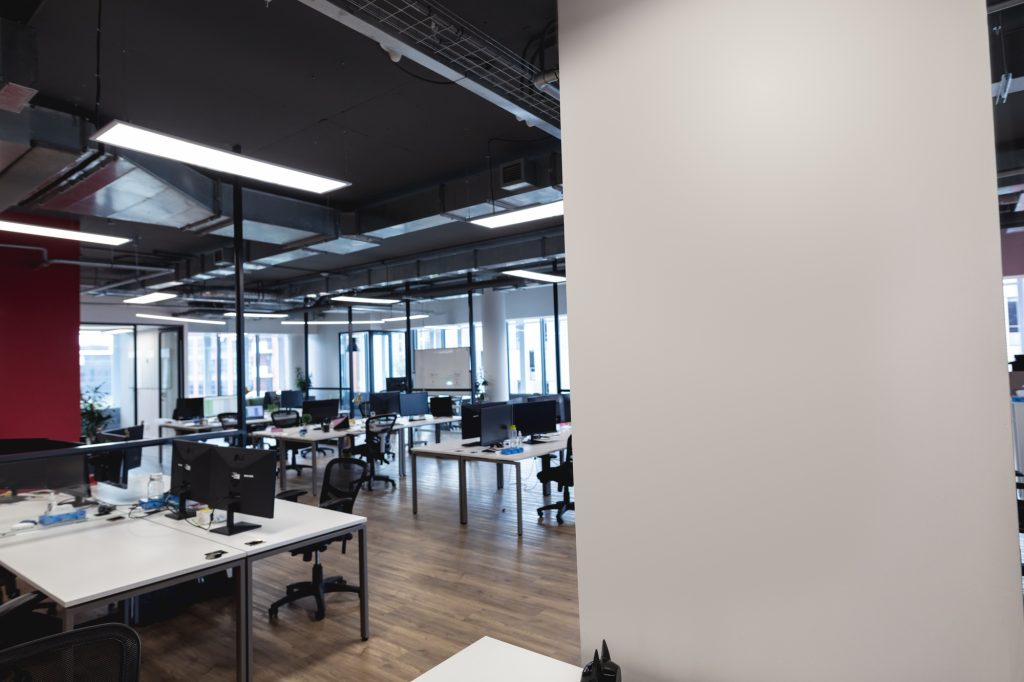 Interior of empty modern office with desks and computers