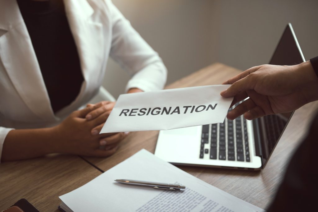Male employee handed out a resignation envelope to the manager.