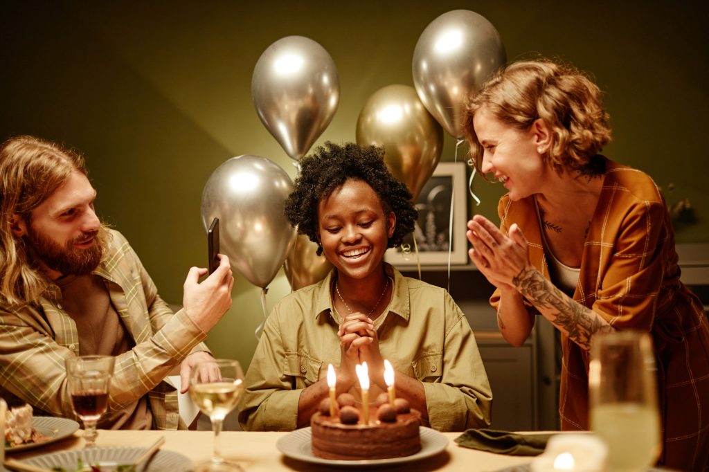 People congratulating woman with birthday